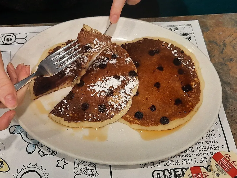 Chocolate chip pancakes dusted with icing sugar