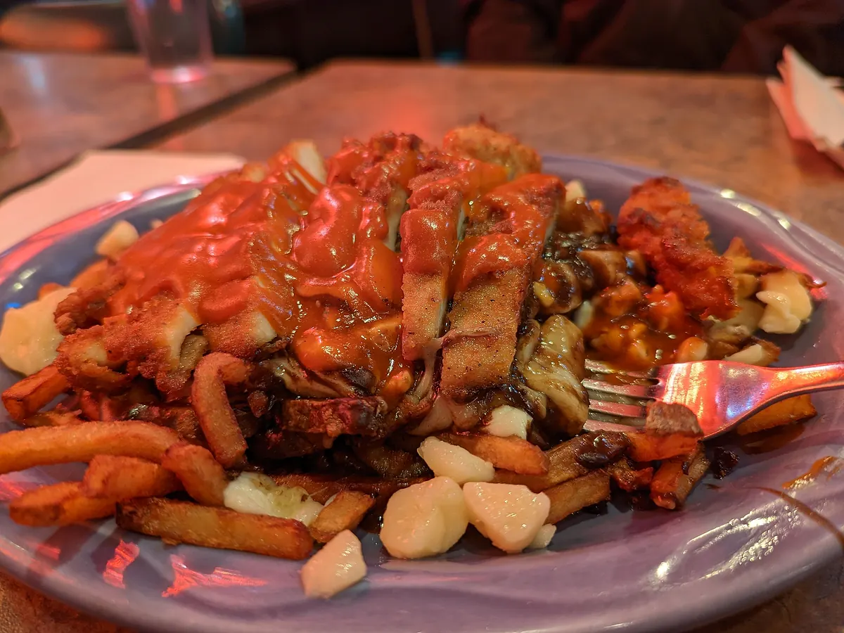 Buffalo chicken poutine piled on fresh-cut fries with cheese curds and gravy